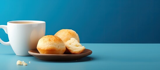 Coffee and cheese bread Pão de queijo served in a blue bowl copy space image - obrazy, fototapety, plakaty