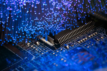 Printed circuit board with a chip illuminated by fiber optics