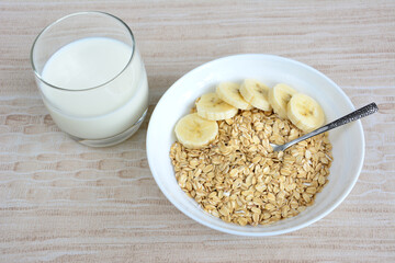 oatmeal with banana slices and spoon top view 