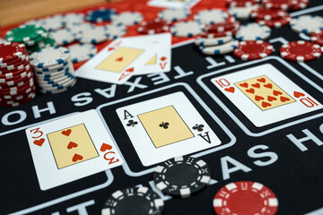 Poker hight combination with play card and chips on casino club