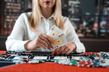 woman play at casino and showing two aces for win