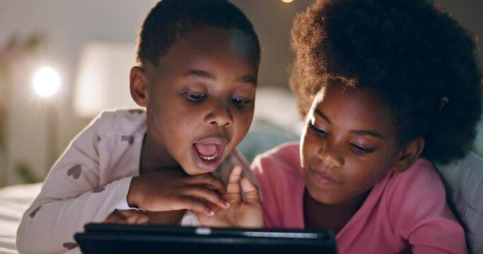 Children, touch or tablet at night for games, bed or digital tech for love or care, siblings or together in bonding. African kids, brother or sister by touchscreen, streaming cartoons or storytelling