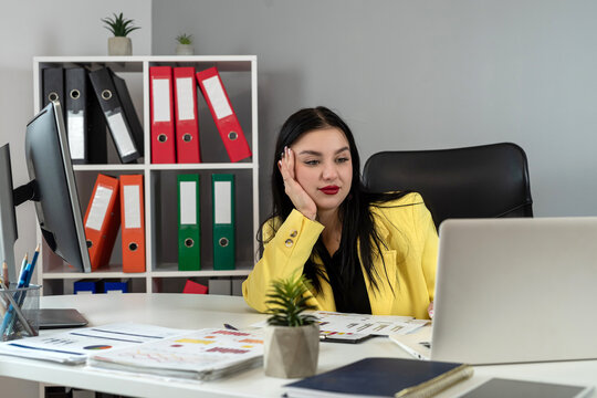  beautiful young businesswoman using laptop and work with finance documents at office