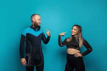 Sport people. Happy successful man and woman in fitness eguipment on blue background