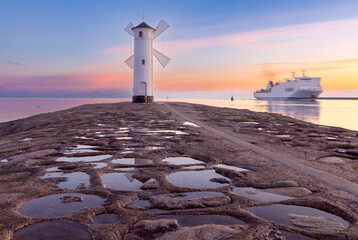 Swinoujscie. The famous stone lighthouse in the form of a windmill at dawn.
