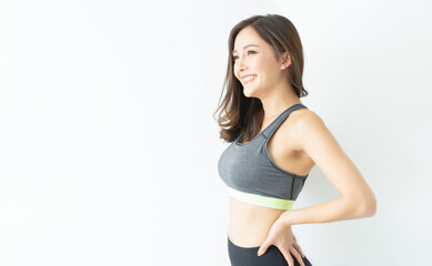 Portrait sport Asian Korean beauty body slim woman in sportswear standing relax and smiling looking up isolated over white wall background with copyspace for text. Diet concept. Fitness and healthy