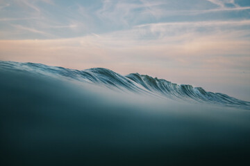 Perfect Breaker/ a perfect wave breaking off the coast in the North Sea at sunset.