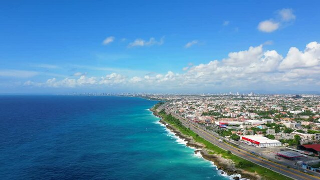 Aerial view of Santo Domingo este. The Autopista Las Americas along the rocky shore of turquoise caribbean sea. Expressway from the airport to the capital of Dominican Republic