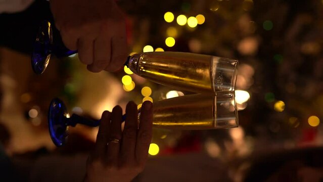 Glasses of champagne on New Year's Eve against the backdrop of Christmas lights.