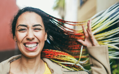 Mixed race girl smiling in front of camera during winter time - Fashion and trendy concept - Soft...