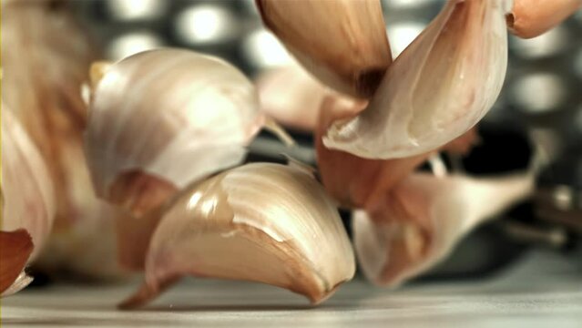 Fresh garlic falls on the table. Filmed on a high-speed camera at 1000 fps. High quality FullHD footage