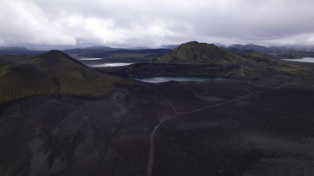 DRONE AERIAL FOOTAGE: Blahylur lake, spelled Bl&aacute;hylur in Icelandic and also known as Hnausapollur, is a stunning crater lake located near Landmannalaugar in the Southern Highlands, Iceland.