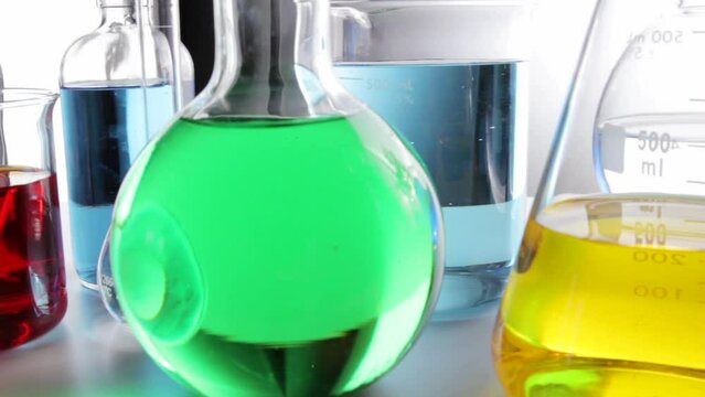 Сamera pans along beakers fla