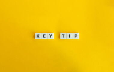 Key Tip Phrase on Block Letter Tiles on Yellow Background. Minimal Aesthetic.