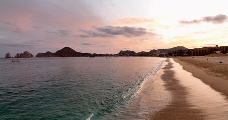Cabo San Lucas Mexico Waves Break on Beach Shore During Colorful Morning Sunrise