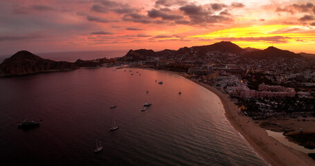 Glorious Red Sky Sunrise Over Cabo Mexico Bay with Yachts and City Beach