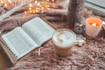 Cup of coffee and open Bible, winter morning mood