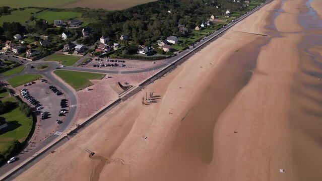 DRONE AERIAL FOOTAGE: Les Braves (The Braves) is a sculpture in tribute to the Allies that landed on Omaha Beach. The sculpture is located in Vierville-sur-Mer on Omaha beach, Normandy, France.