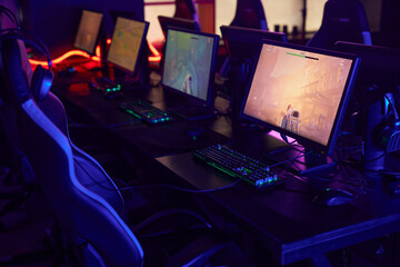 Background image of professional gaming setup in cybersports club interior with video game playing...