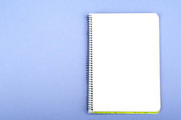 Blank notepad on a wooden surface. Top view.