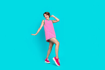 Full length photo of overjoyed cheerful girl wear bright outfit dancing at night club birthdy party isolated on cyan color background