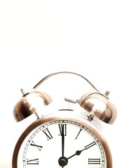 Close up of copper retro alarm clock at 2am 2pm isolated on white with copy space to add text