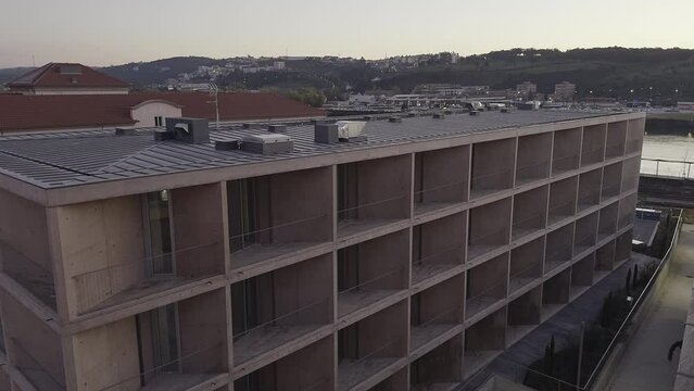 Modern building at the end of the day overlooking the Mondego River.