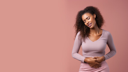 Afro american woman wincing in pain and hand rubbing stomach