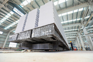 Workers are working intensively on the production line of new building materials - lightweight...