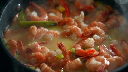 Nutritious shrimps and vegetables inside pan, cooking healthy food boiling water. preparing seafood