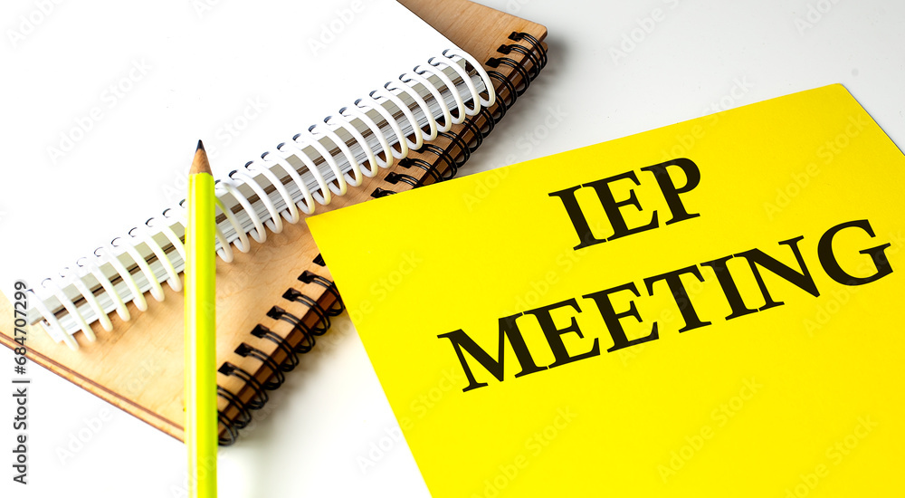 Poster iep meeting text written on a yellow paper with notebook