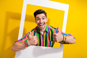 Photo of young man in retro shirt thumbs up sign being drunk party he started inside instant shot frame isolated on yellow color background