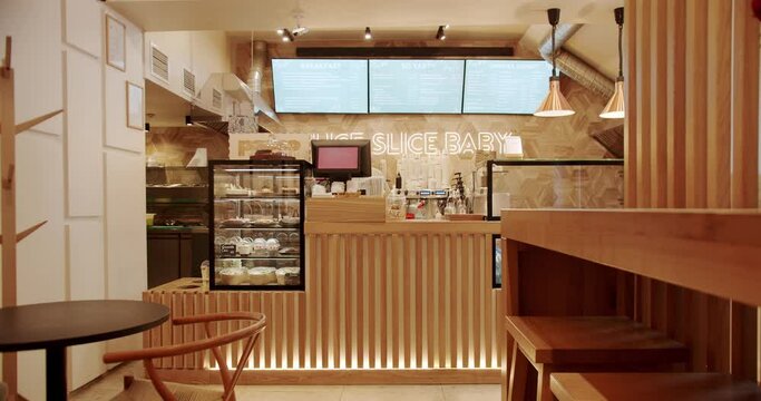 Modern wooden chair and table. Eco Friendly Cafe. Empty dining fabric and wooden chair. Modern equipment in the cafe. Wooden counter for receiving customers. Wooden lines, Wood Slat Wall.