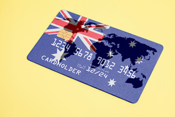 Bank credit plastic card with flag of Australia and world map.