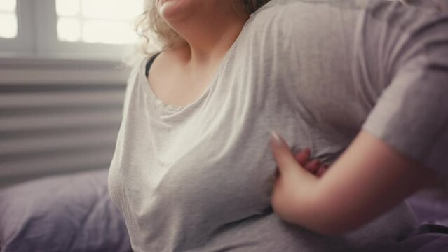 Overweight female suffering breast pain, mastitis disease, hormonal disorder