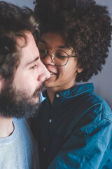 Young multiethnic couple hugging smiling together at home