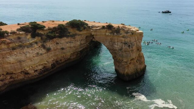 Natural arch above ocean, Arco de Albandeira, Algarve, Portugal. Stone arch at Praia de Albandeira, Lagoa, Algarve, Portugal. View of the natural arch Arco da Albandeira in the Algarve, Portugal.