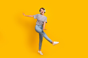 Full length portrait of nice positive person have fun dancing listen favorite playlist isolated on yellow color background