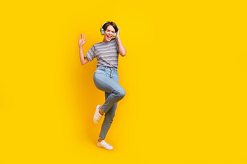 Fototapeta na wymiar Full body portrait of positive nice lady touch headphones dance empty space ad isolated on yellow color background