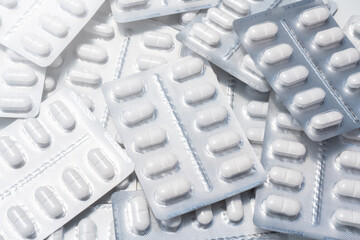 pack of white pills stacked in daylight