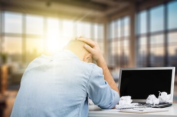 business man has stress and headache works in office