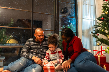 Holidays and celebration concept - multiethnic group of happy friends or family having christmas dinner party at home