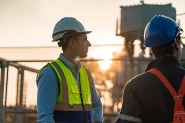 Fotobehang professional engineer and construction foreman team person with safety hard hat helmet discussion to working in business industry of architect job teamwork, a work at building construction site © chokniti