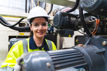 Female engineer using laptop computer for safety control checks or manufacturing maintenance work...