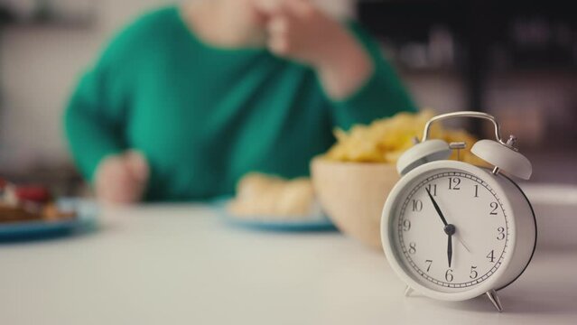Hungry obese woman overeating before 6pm, unhealthy habit, eating disorder
