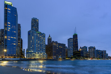 View of Chicago skyline from a beach on lake Michigan at twilight in spring