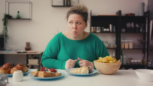 Overweight woman secretly biting cake, unhealthy food addiction, stress eating