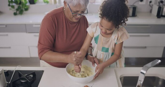 Baking, family and grandparent with little girl helping and mixing cookie dough for fun bonding activity at home. Adorable child preparing chocolate chip cake treat with her grandmother in kitchen