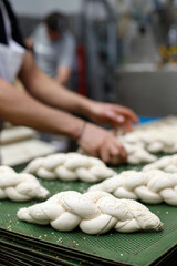 Making braided bread in a bakery. Traditional Shabbat challah
