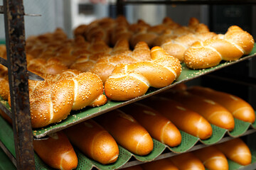 Jewish Challah bread for shabbat, on a rack trolley in a bakery